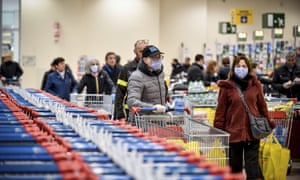 People wear masks at a supermarket in Milan.