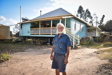 Denver Kanowski stands outside his raised timber Kogan home on a dirt yard