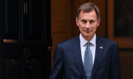Britain's Chancellor of the Exchequer Jeremy Hunt walks at Downing Street.