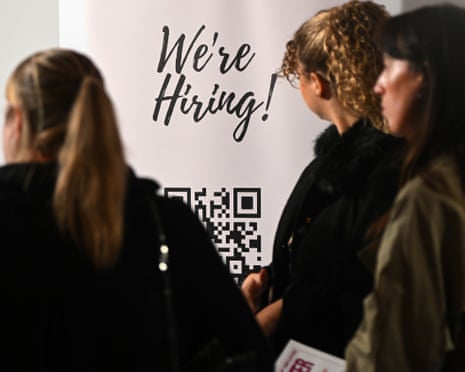 A sign reading "We're Hiring" at the Manchester Job Show.