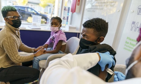 JT West, age nine, receives the vaccine at Asthenis Pharmacy in Providence, Rhode Island.