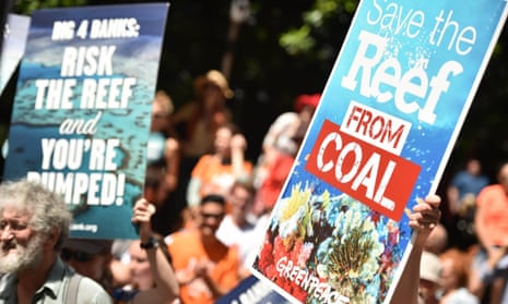 Protesters hold banners outside the headquarters of the Commonwealth Bank to say no to coal expansion on the Great Barrier Reef as part of “Global Divestment Day” in Sydney on February 13, 2015.