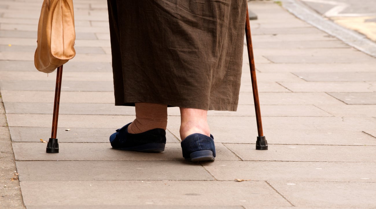 An older woman with walking sticks