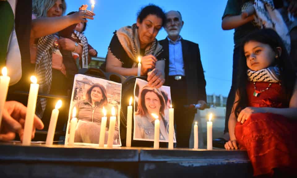 People take part in a candelight vigil outside a UN building in Beirut to denounce the killing of the Al Jazeera reporter Shireen Abu Akleh, on Saturday.