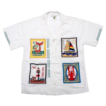 A white shirt with four colour postcard designs on it on a white background
