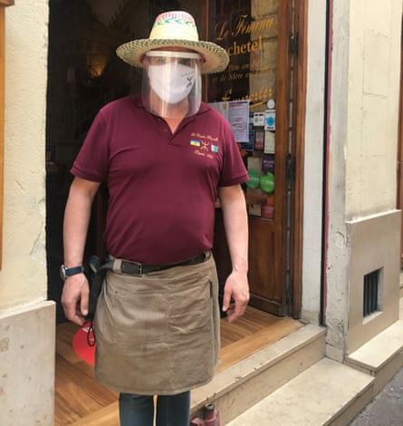 Mustapha Kachetel in hat mask and plastic visor outside restaurant