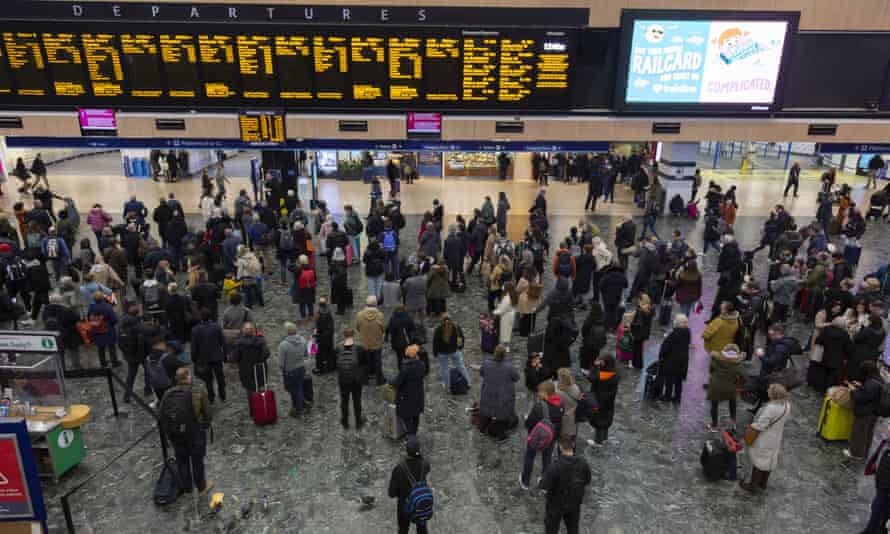 Storm Eunice: London added to red weather warning amid ‘danger to life’ | UK weather 2 People wait in line at a London train station as a result of the cancellation of some services due to the storm.