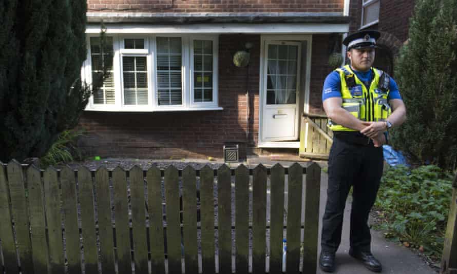 A police officer stands outside a property during a search of a house in Pentwyn, which is believed to be the home of Darren Osborne.