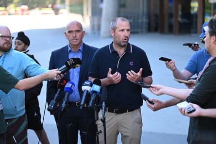 Melbourne Cricket Club CEO Stuart Fox, centre left, and head curator, Matthew Page, centre right.
