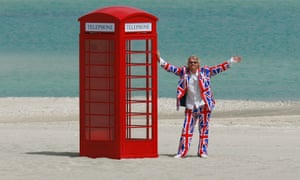 Sir Richard Branson poses with a red telephone box on Britain.