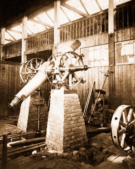 Black and white photo of a telescope mounted on two sets of brickwork