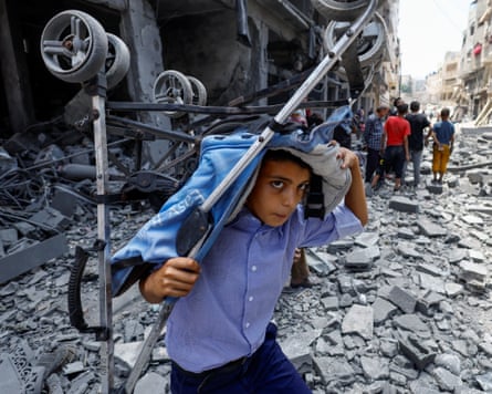A Palestinian boy with a stroller in Gaza City