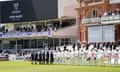 Cricketers line up in front of the Lord's Pavilion during a minute's silence for Josh Baker