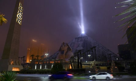 The light of the Luxor pyramid hotel and casino shines through a rare snowfall in Las Vegas.