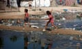 Children walking past dirty water in Gaza