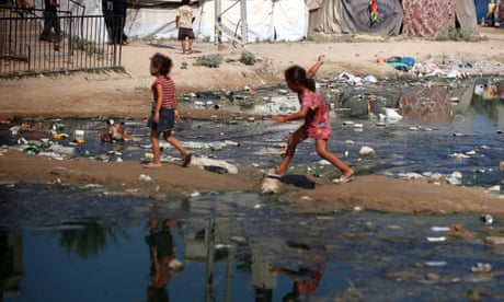 Children walking past dirty water in Gaza