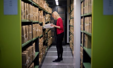 A member of staff in the repositories of the National Archives in Kew.