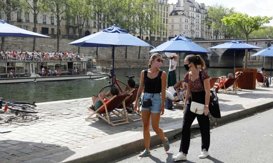 Pedestrians wearing protective face masks walk along the bank of the river Seine, Paris, 15 August 2020. France reported 3,310 new coronavirus infections in the past 24 hours, a post-lockdown high for the fourth day in a row.