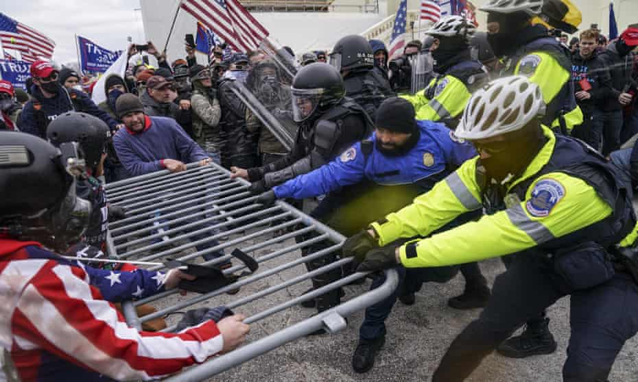 Rioters try to break through a police barrier at the Capitol in Washington on 6 January.