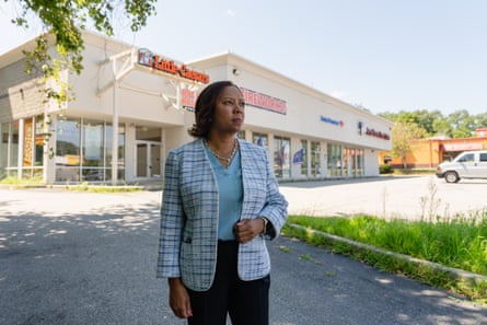 A woman in front of a commercial building.
