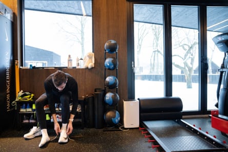 Jakob Ingebrigtsen putting on running shoes in his gym