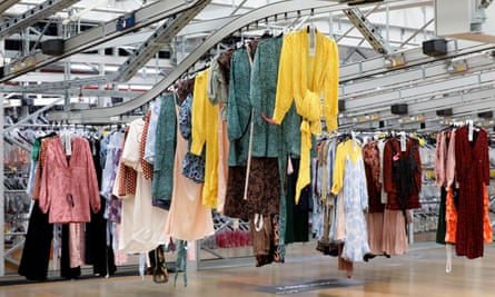 Garments on rails travelling through the Advanced Clothing Solutions warehouse in Motherwell, Scotland