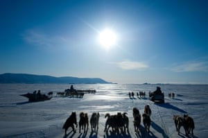 Dog teams and Inuit hunters in Qaanaaq, Greenland, heading out in the spring during the period of the midnight sun.