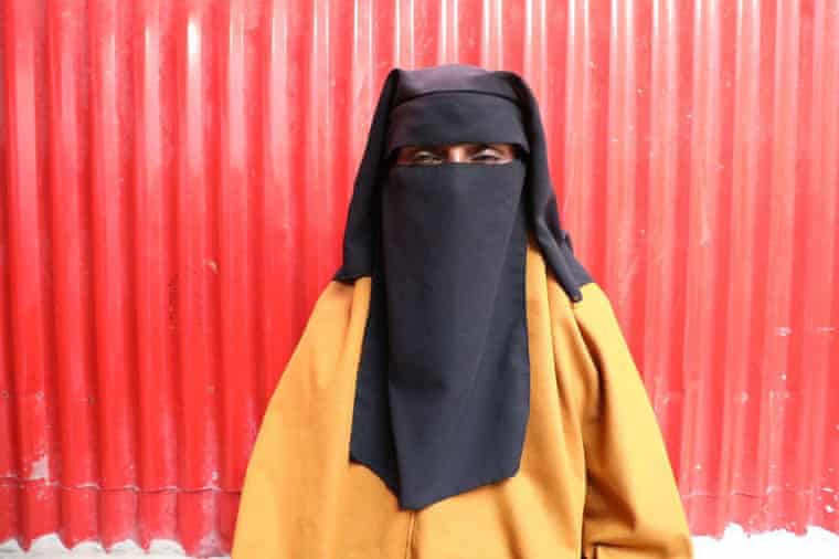 A woman in a full niqab veil