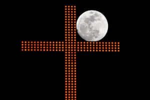 A cross in downtown Beirut, Lebanon, frames the moon