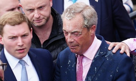 Reform UK party leader Nigel Farage reacts after a woman threw a drink over him, as he launches his election candidacy at Clacton Pier on June 4, 2024 in Clacton-on-Sea, England