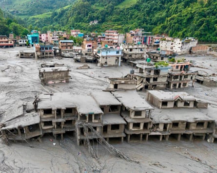 An aerial view of houses covered in sludge.