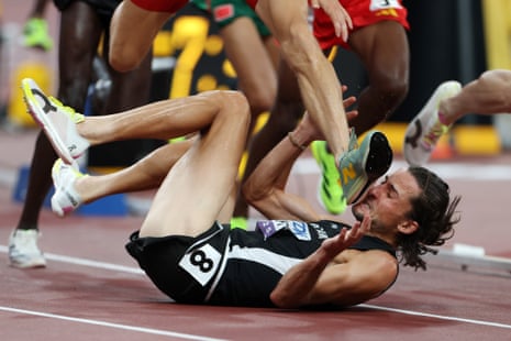 Geordie Beamish is hit by the foot of Jean-Simon Desgagnés of Canada as the New Zealander falls to the ground during the the men’s 3,000m steeplechase heats at the World Athletics Championships.