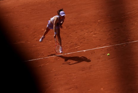 Iga Swiatek fires off a serve during her straight sets victory over Magda Linette.