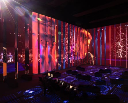 Footage of David Bowie performing is projected on all four walls and the floor in the immersive space.