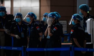 Security workers wait for the passengers in the deserted Pudong International Airport in Shanghai, China, 22 August 2021.