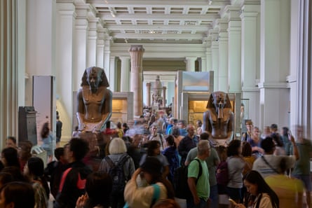 Crowds in the Egyptian gallery with two huge sculptures of pharaoahs.