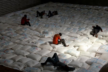 Labourers rest as they offload relief bags of grains sent from Ukraine at the WFP warehouse in Adama town, Ethiopia, September 2022.