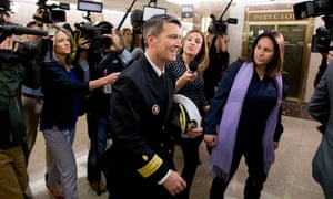 Ronny Jackson (centre) is followed by members of the media following a meeting in Washington DC.