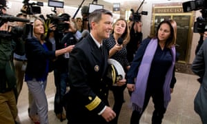 Ronny Jackson (centre) is followed by members of the media following a meeting in Washington DC.