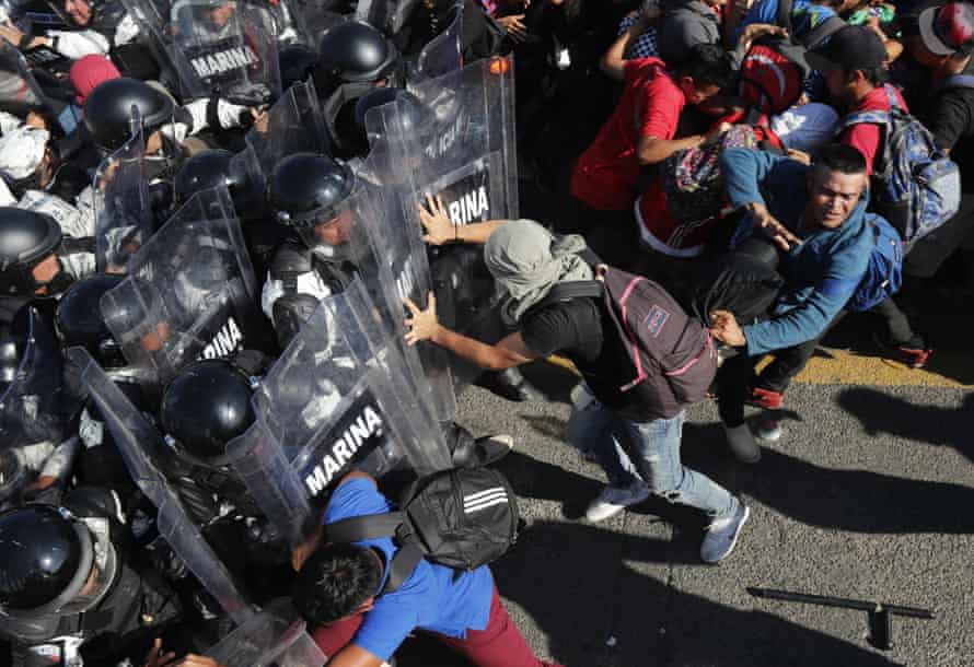 Migrants charge at members of the Mexican national guard at the border crossing between Guatemala and Mexico, near Ciudad Hidalgo.