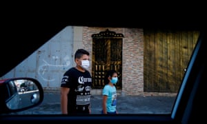 A Palestinian boy and girl wearing protective masks in Gaza City.
