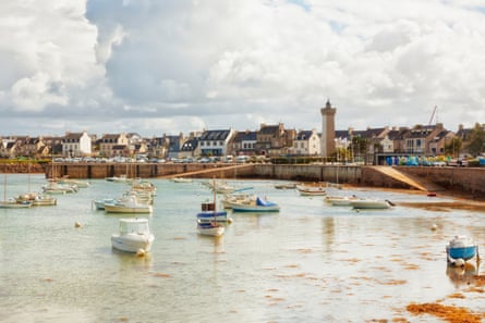 Marina and lighthouse of Roscoff, Brittany with small boats in the foreground