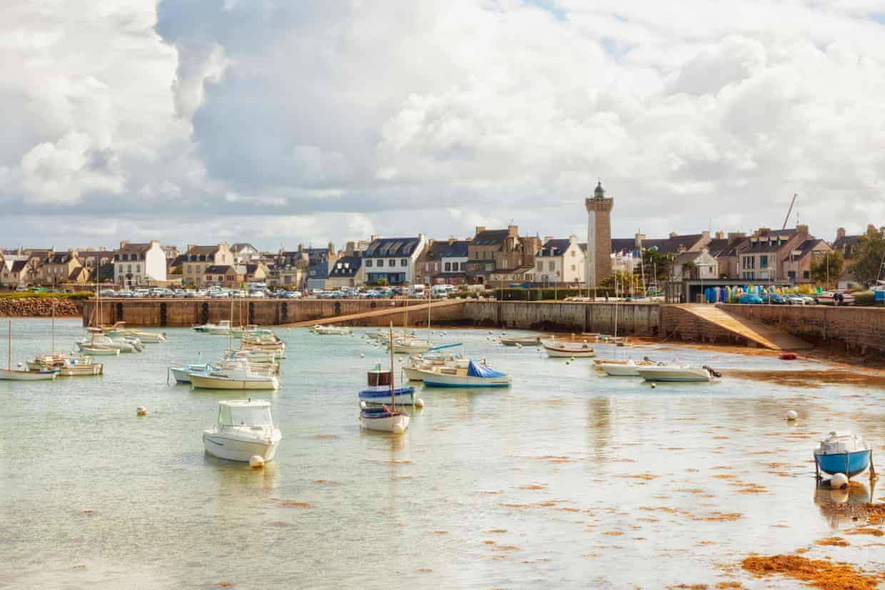 Marina and lighthouse of Roscoff, Brittany with small boats in the foreground