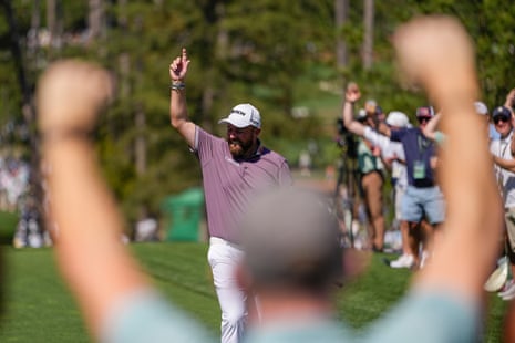 Shane Lowry, of Ireland, waves after a hole-in-one on the 6th hole.