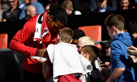 Southampton’s Virgil van Dijk signs autographs for fans before taking his place on the bench.