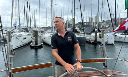 Captain of the boat, John Townley, carefully reverses his yacht into its position as the crew prepare for the Sydney to Hobart race.