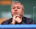 Roman Abramovich rests his chin on his clasped hands, looking pensively ahead