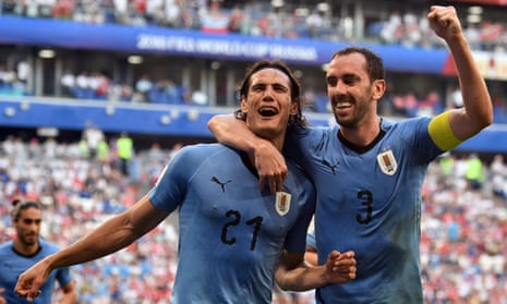 Uruguay’s Edinson Cavani celebrates with Diego Godin after scoring the third goal.