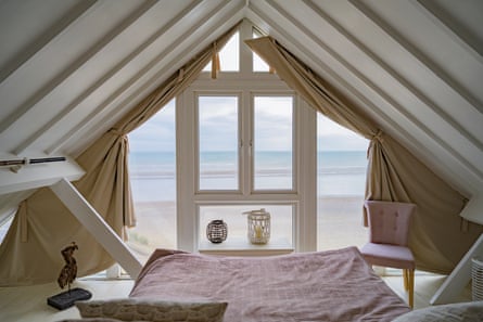 A bedroom looking out over the ocean