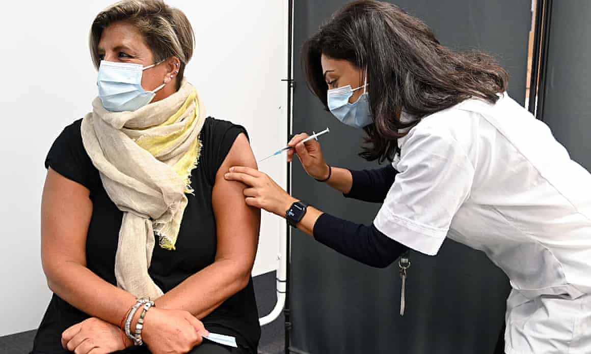 A care worker receives a Covid booster jab in Borehamwood, England